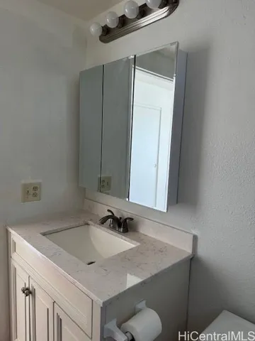 a bathroom with a sink vanity and a mirror