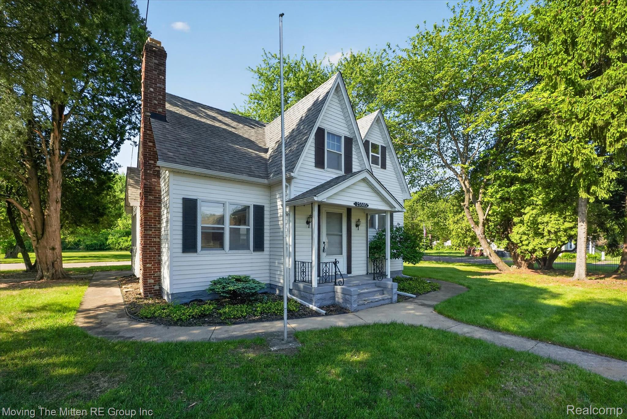 25505 Wick Road Taylor, MI 48180 - Photo 49 of 68 View of front facade featuring a front yard, a chimney, and a shingled roof