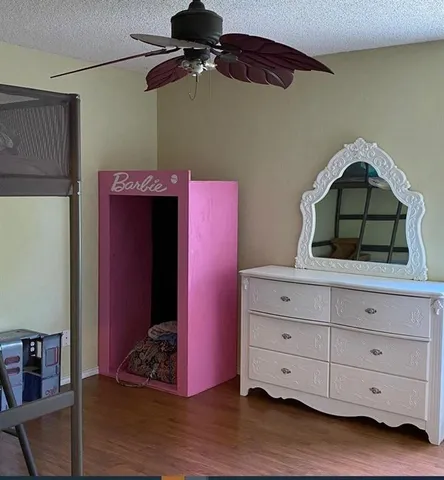 a bedroom with a bed and a desk