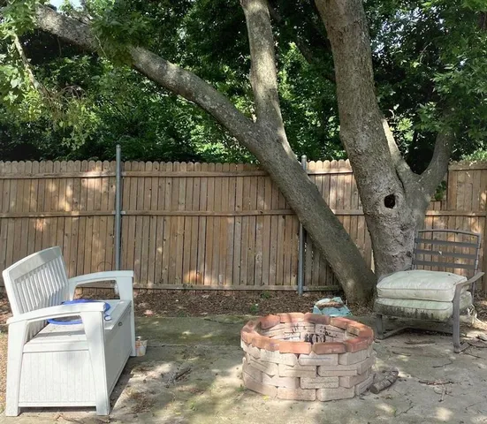 a view of a house with a yard and sitting area