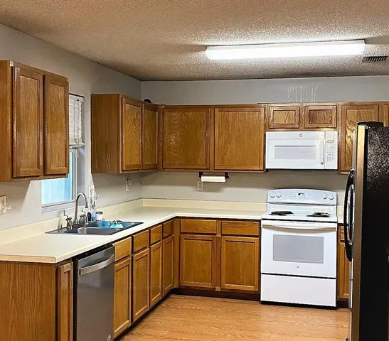 a kitchen with a sink stove and cabinets