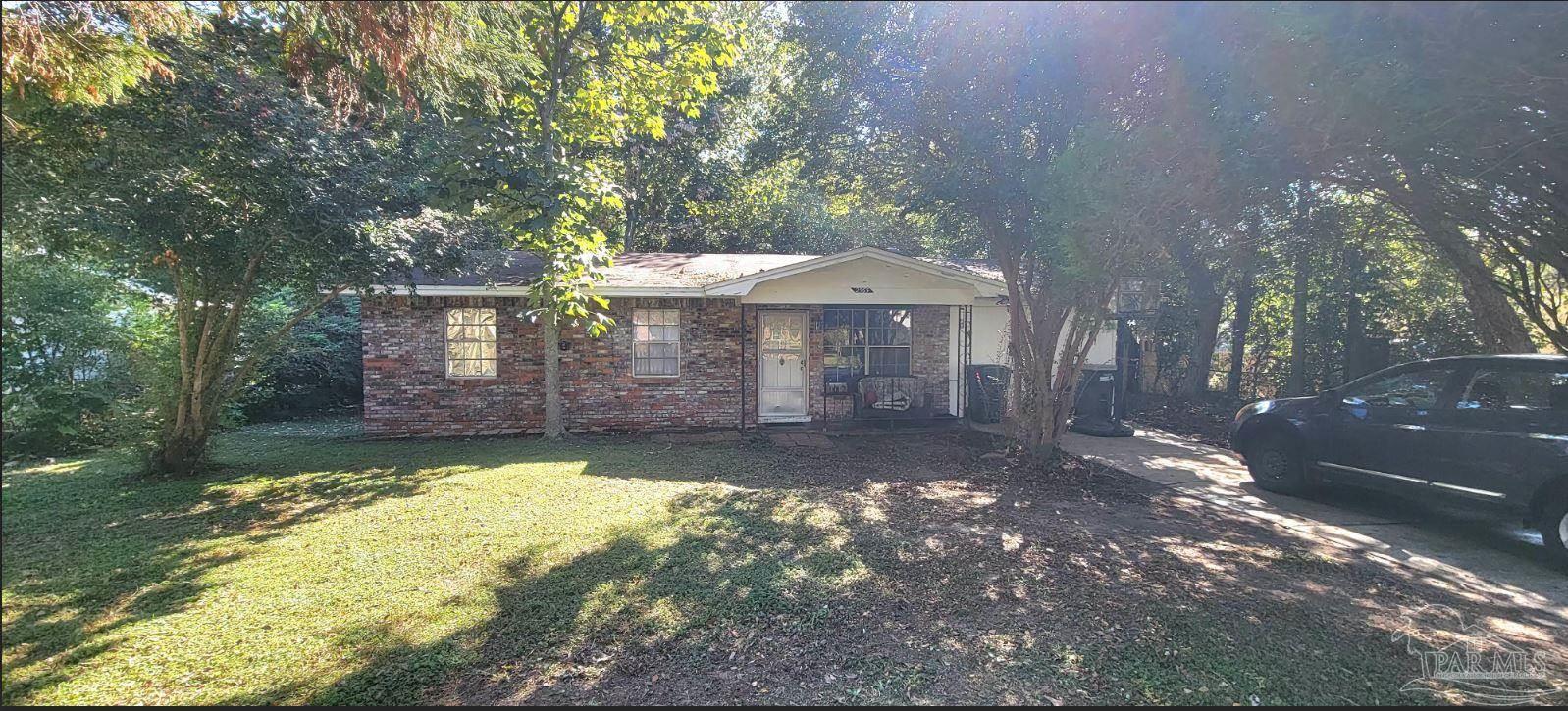 a view of a house with a yard and sitting area
