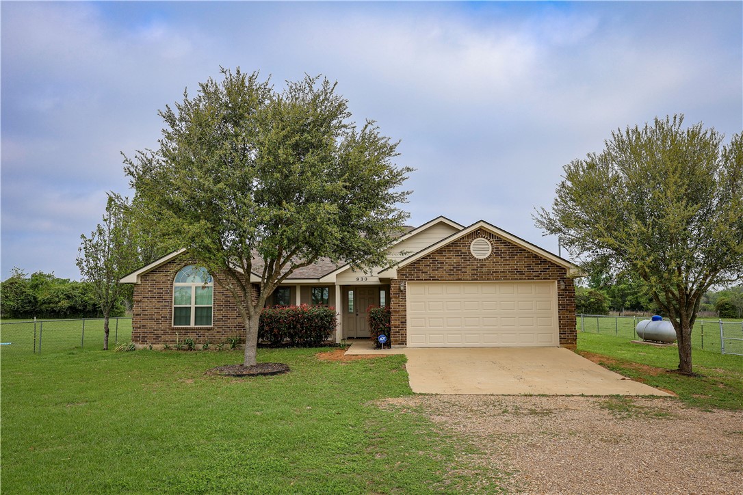 930 County Road 357 Gause, TX 77857 - Photo 10 of 17 a front view of a house with a garden and trees