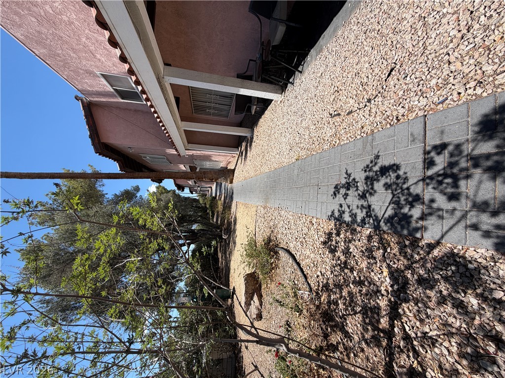 2236 East Desert Inn Road Las Vegas, NV 89169 - Photo 33 of 34 A quaint pathway alongside the residence offers a tranquil outdoor retreat.