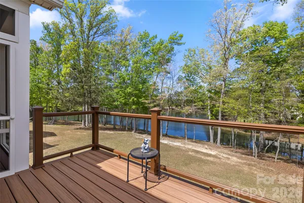 a view of balcony with wooden floor and outdoor seating