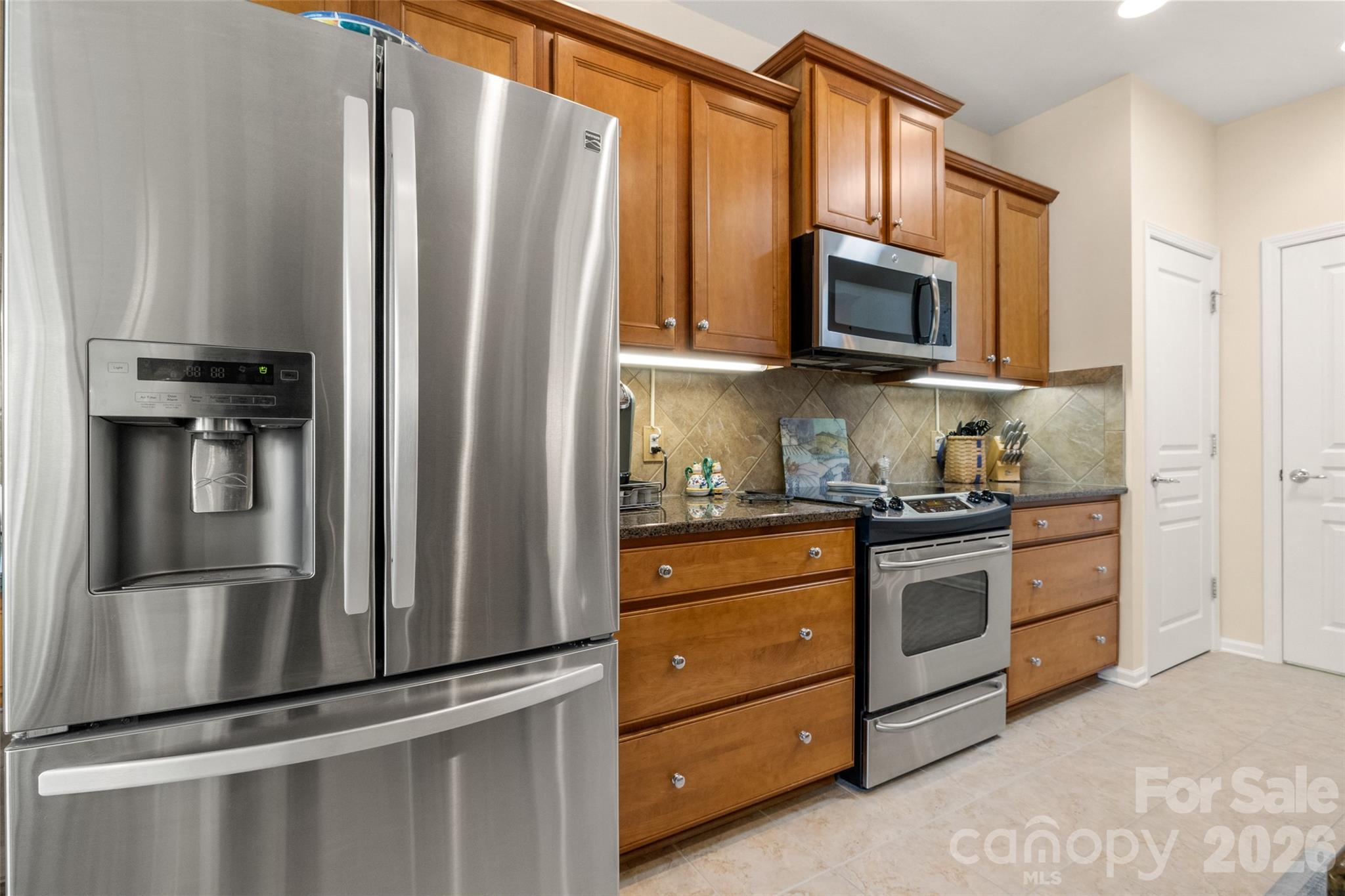 27064 Sanderling Court Fort Mill, SC 29707 - Photo 13 of 48 a kitchen with stainless steel appliances granite countertop a refrigerator stove and microwave