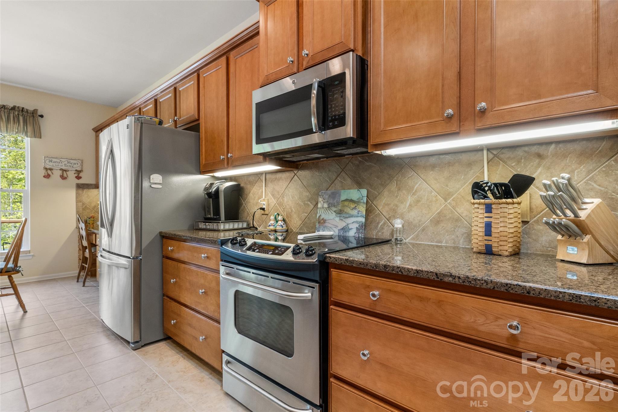 27064 Sanderling Court Fort Mill, SC 29707 - Photo 14 of 48 a kitchen with stainless steel appliances granite countertop a refrigerator stove and sink