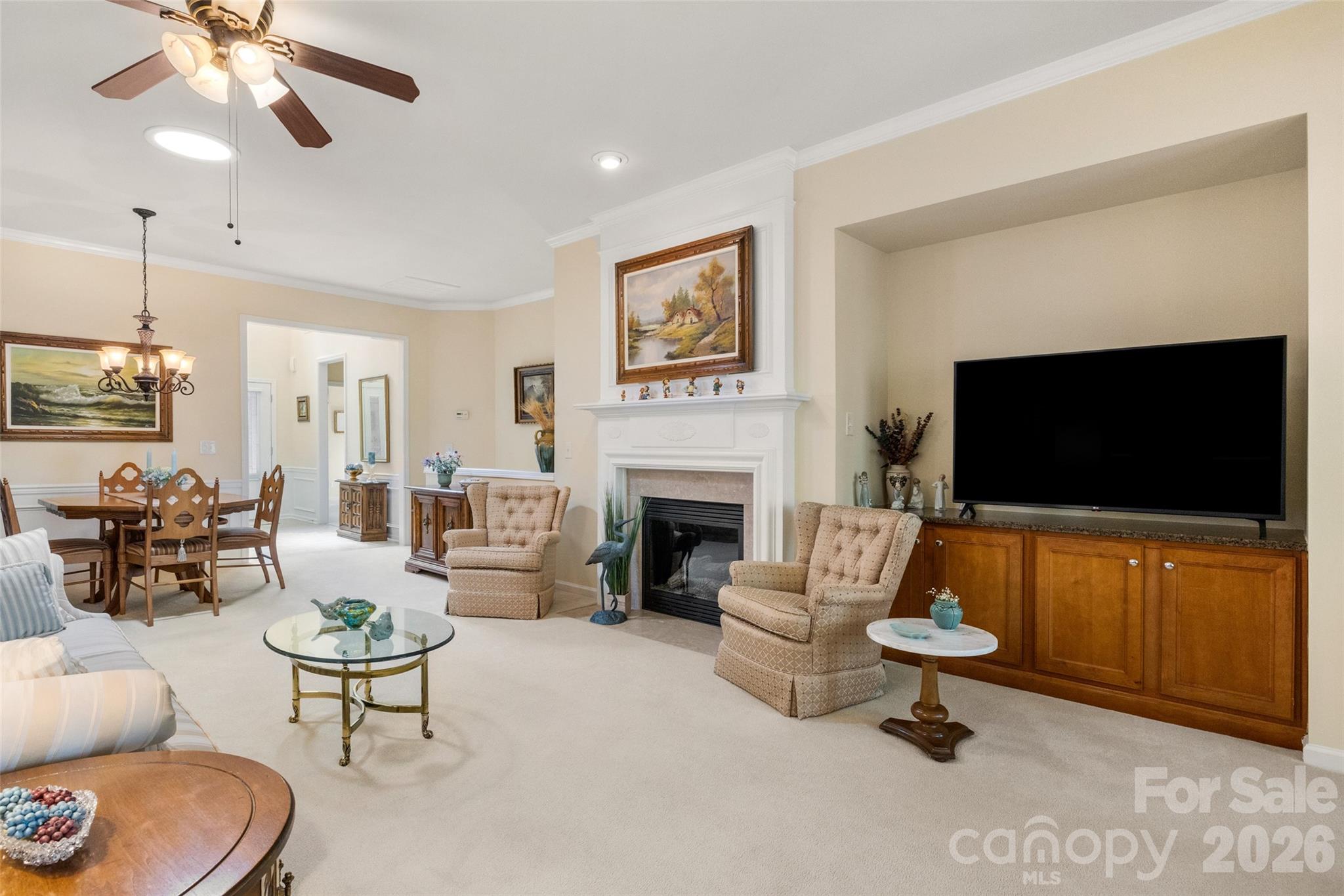 27064 Sanderling Court Fort Mill, SC 29707 - Photo 8 of 48 a living room with furniture a flat screen tv and a fireplace