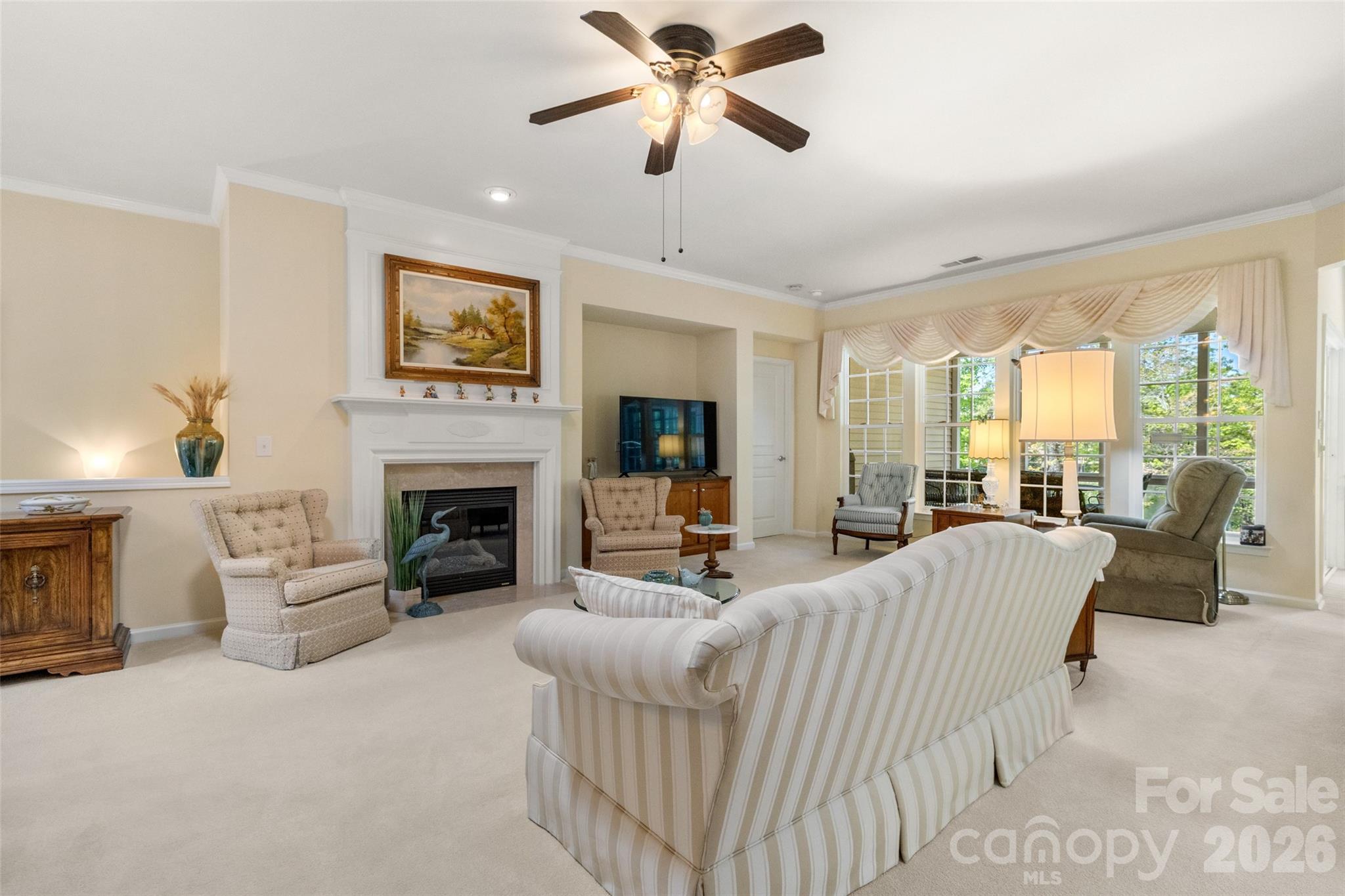 27064 Sanderling Court Fort Mill, SC 29707 - Photo 10 of 48 a living room with furniture a fireplace and a chandelier