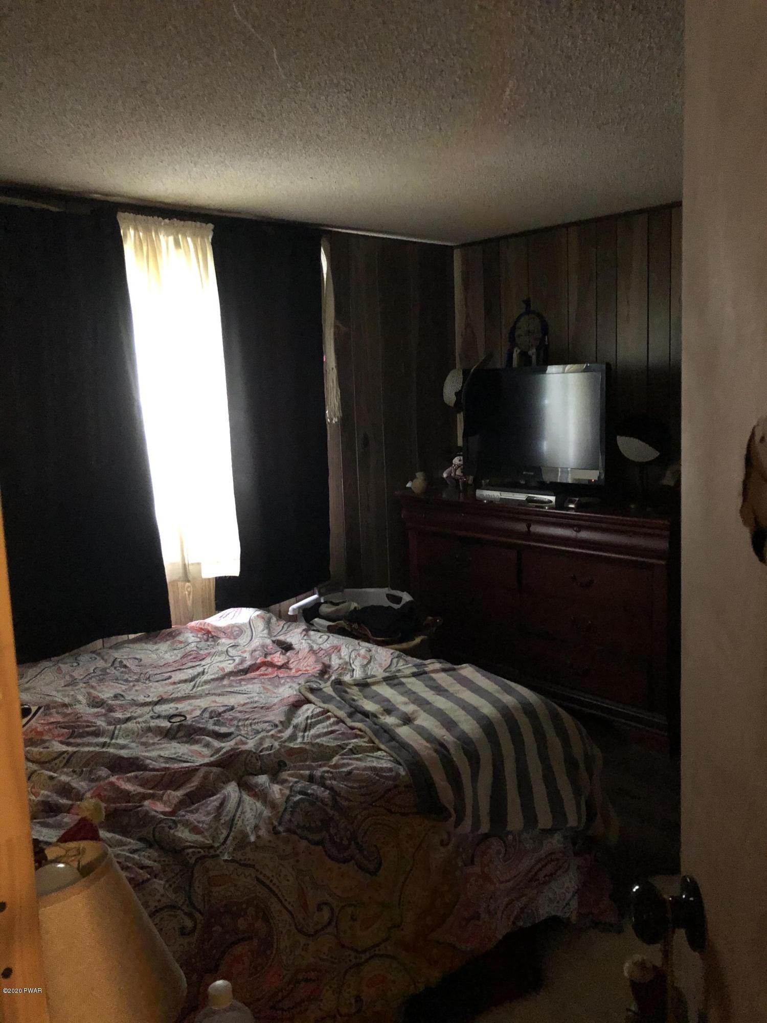 177 Skyview Road Dingmans Ferry, PA 18328 - Photo 12 of 18 a bedroom with a bed and window