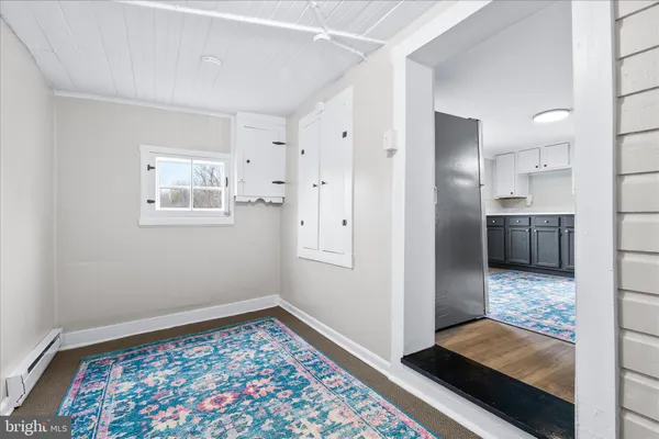 a view of a bathroom with a sink cabinet and a mirror