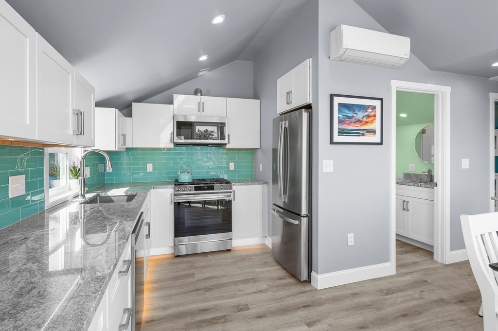 315 R Nauset Light Beach Road Eastham, MA 02642 - Photo 4 of 28 a kitchen with granite countertop a refrigerator stove and oven