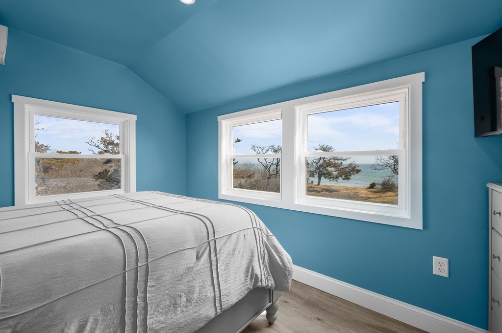 315 R Nauset Light Beach Road Eastham, MA 02642 - Photo 8 of 28 a bedroom with a bed and wooden floor
