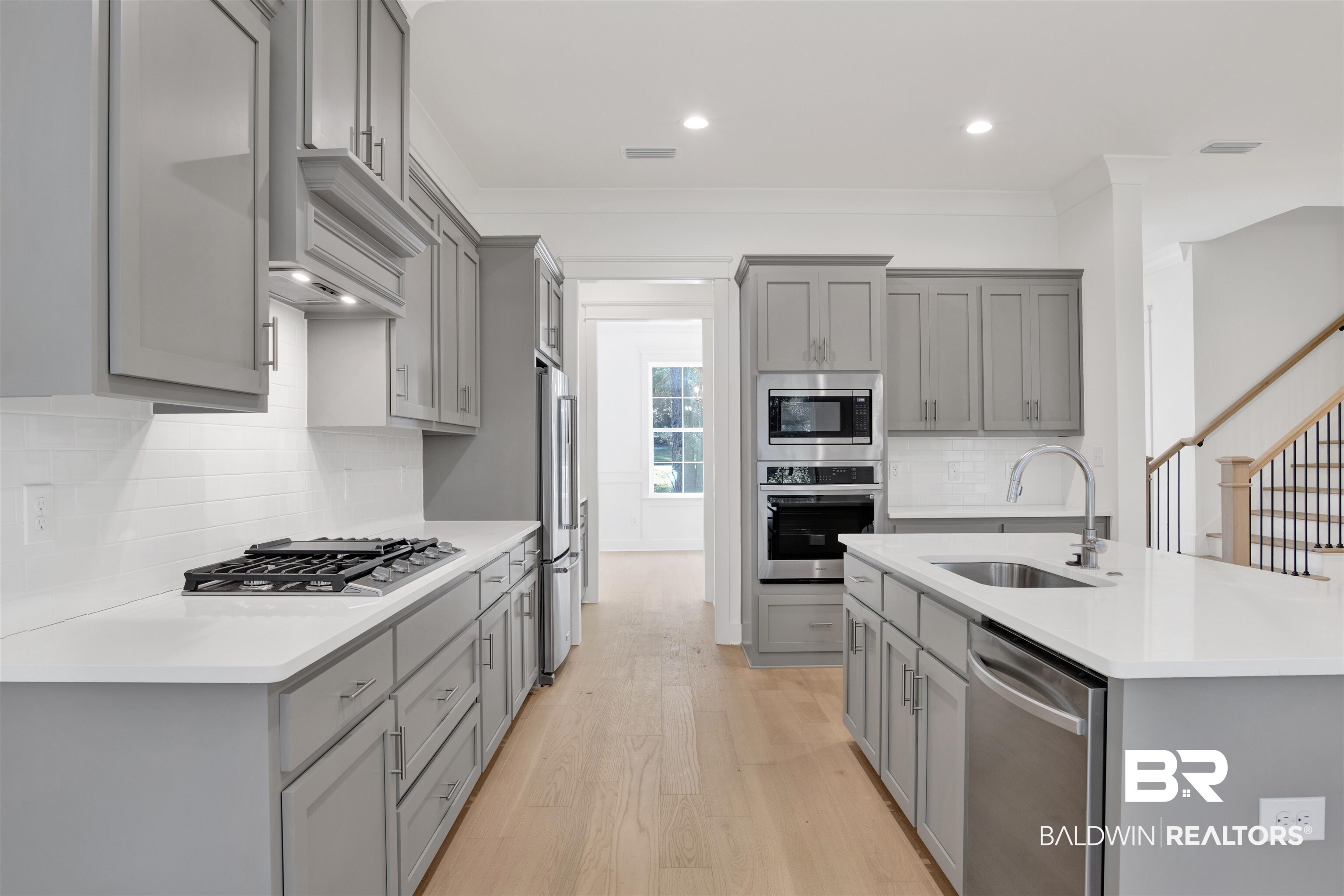 5 Long Leaf Circle Fairhope, AL 36532 - Photo 11 of 44 Kitchen with gray cabinets, sink, light wood-type flooring, and stainless steel appliances