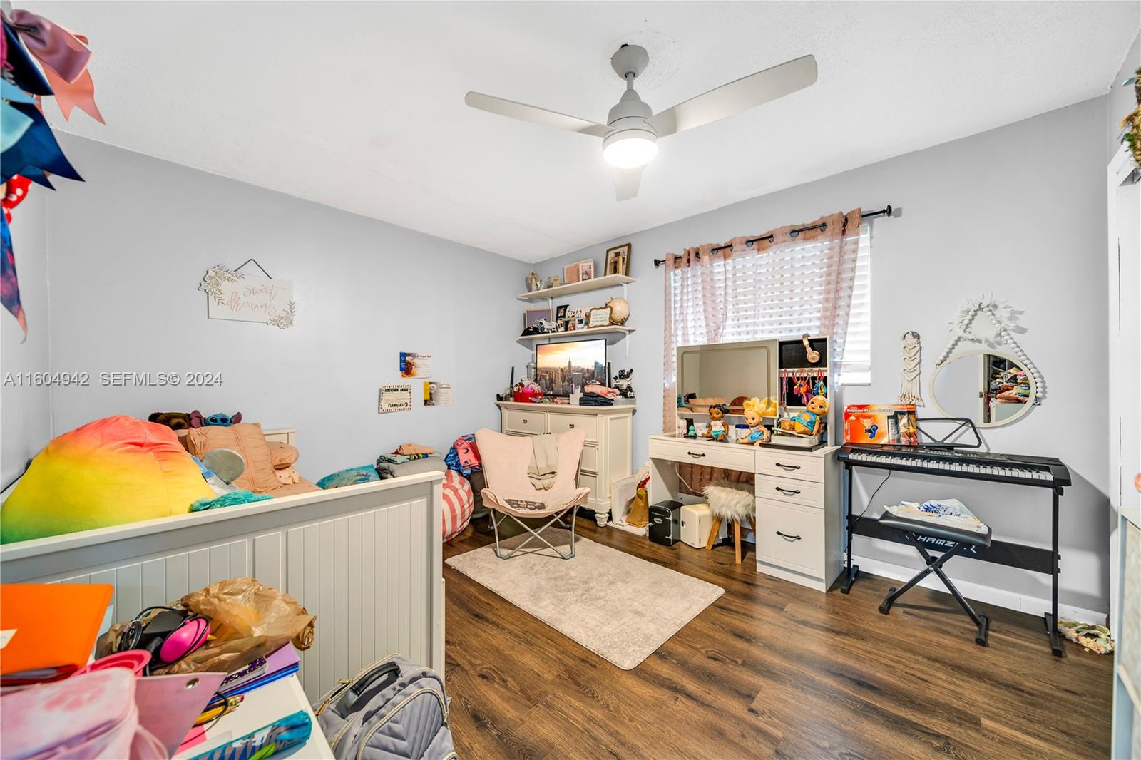 875 East 29th Street Hialeah, FL 33013 - Photo 14 of 38 a room with furniture a clock and a window
