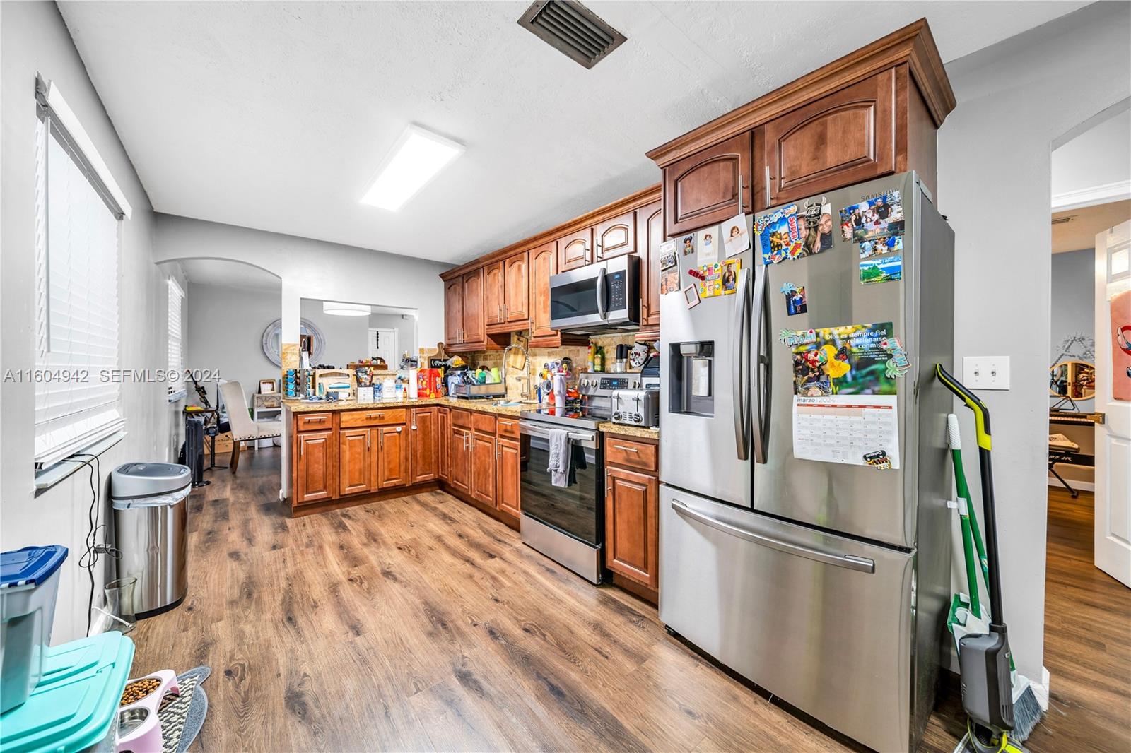 875 East 29th Street Hialeah, FL 33013 - Photo 6 of 38 a kitchen with stainless steel appliances a refrigerator a sink a stove and white cabinets