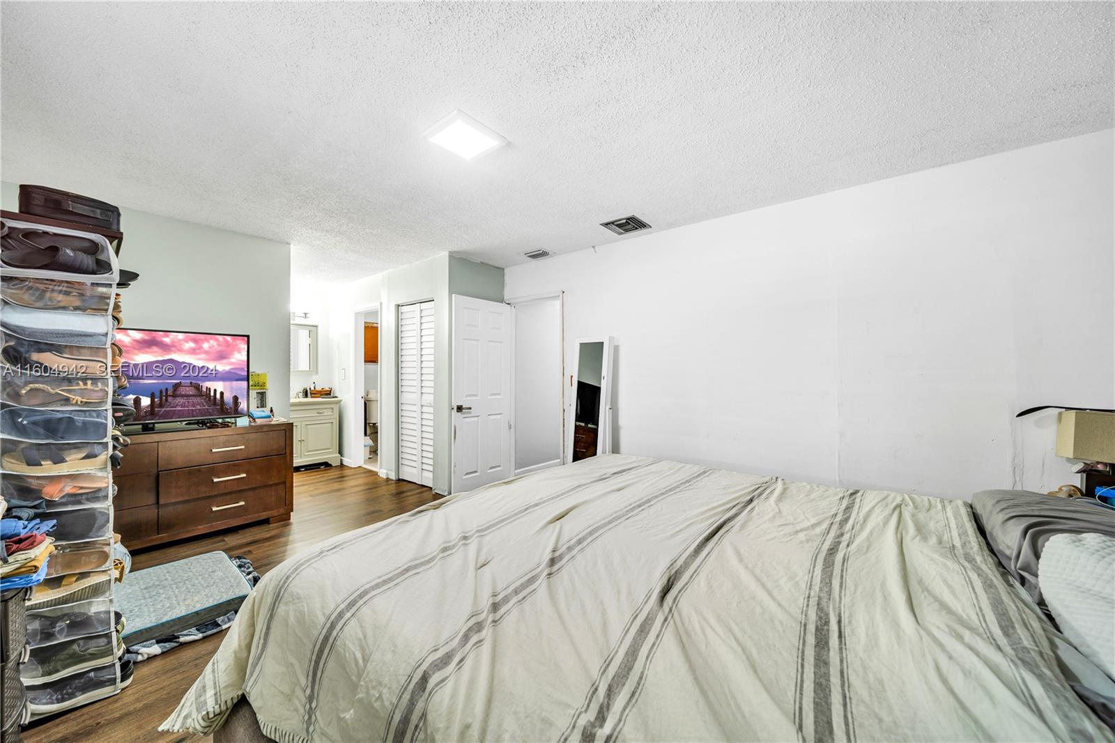 875 East 29th Street Hialeah, FL 33013 - Photo 10 of 38 a bedroom with a bed and a flat screen tv
