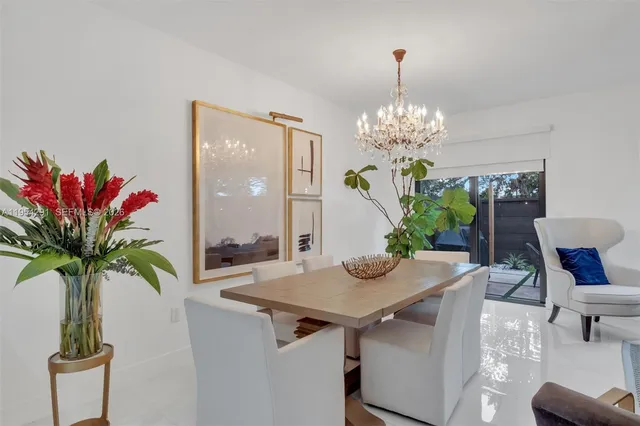 a view of a dining room with furniture and chandelier