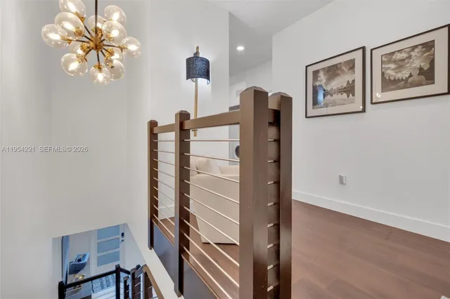 a view of hallway with furniture and wooden floor