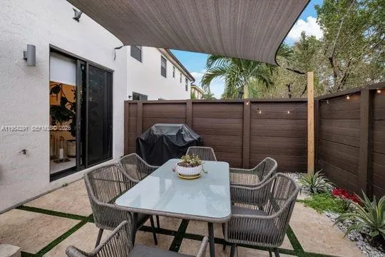a view of a balcony dining table and chairs