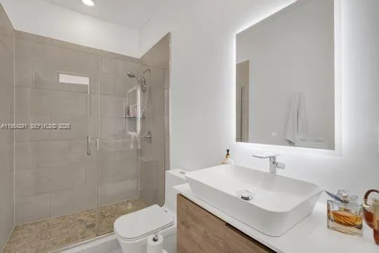 a bathroom with a sink toilet and shower