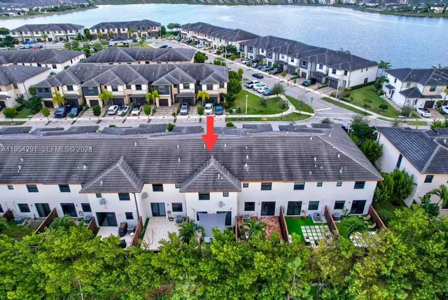 an aerial view of multiple houses with yard