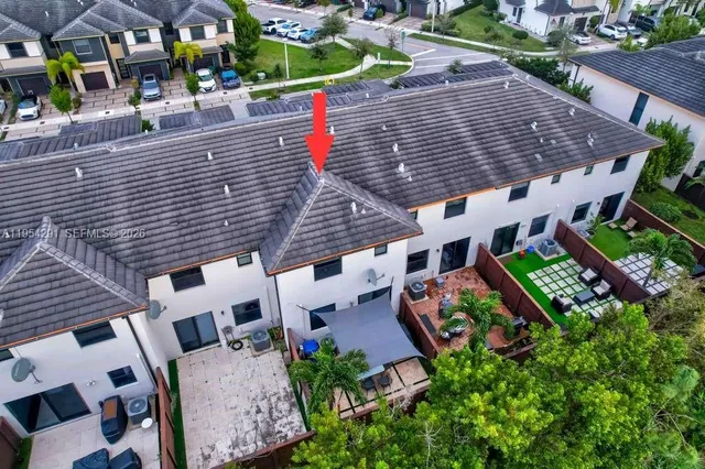an aerial view of a house with a yard and potted plants