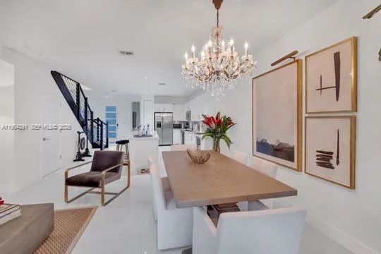 a view of a dining room with furniture and a chandelier