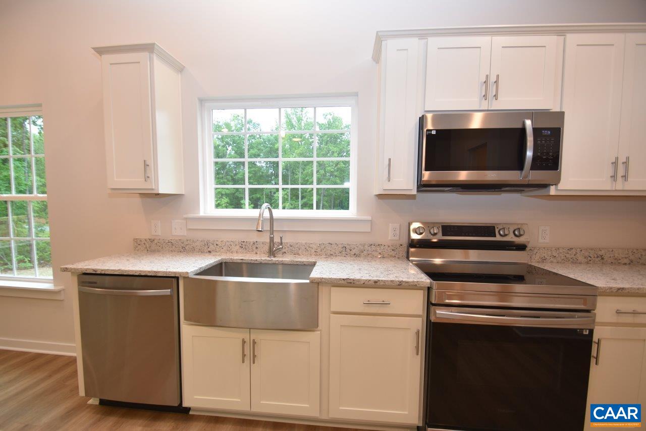 88 Martin Village Road, Unit MV 16D Louisa, VA 23093 - Photo 11 of 37 a kitchen with stainless steel appliances granite countertop a sink and a microwave