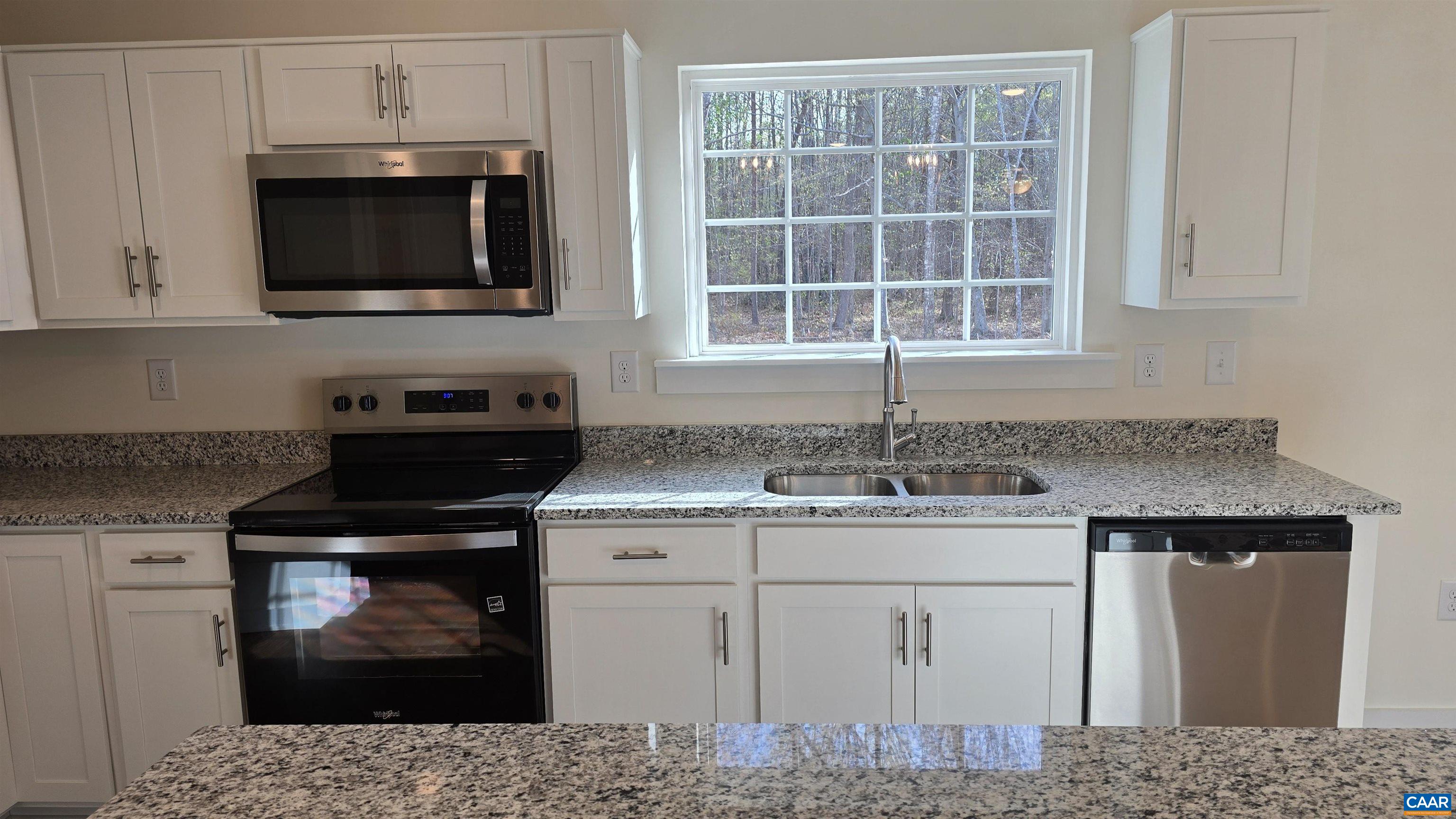 88 Martin Village Road, Unit MV 16D Louisa, VA 23093 - Photo 13 of 41 a kitchen with stainless steel appliances granite countertop a sink stove and microwave
