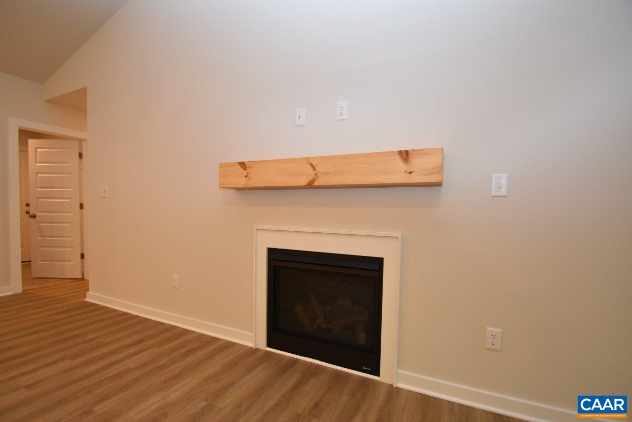 88 Martin Village Road, Unit MV 16D Louisa, VA 23093 - Photo 17 of 37 a view of an empty room with wooden floor and a fireplace