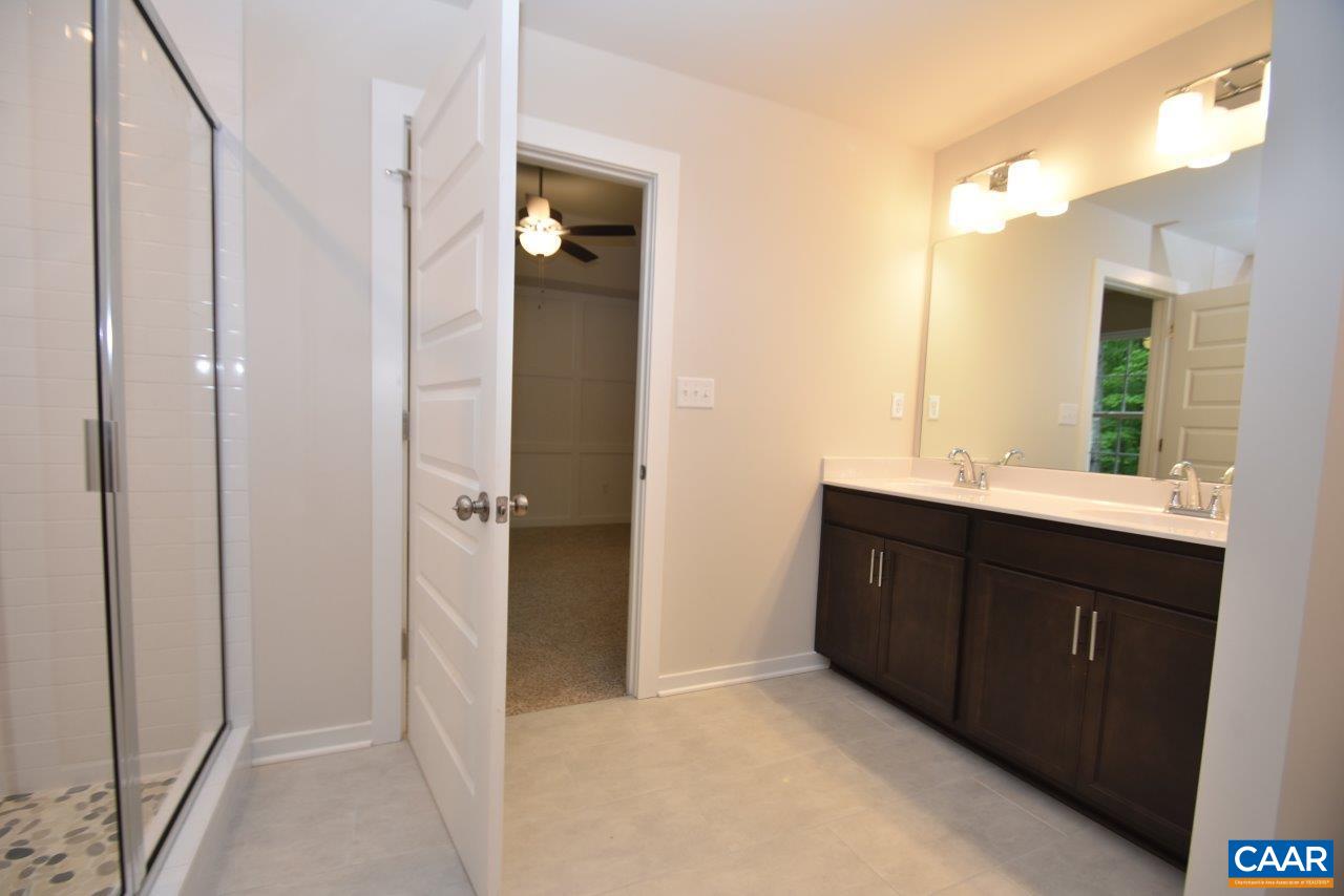 88 Martin Village Road, Unit MV 16D Louisa, VA 23093 - Photo 27 of 37 a bathroom with a double vanity sink and mirror