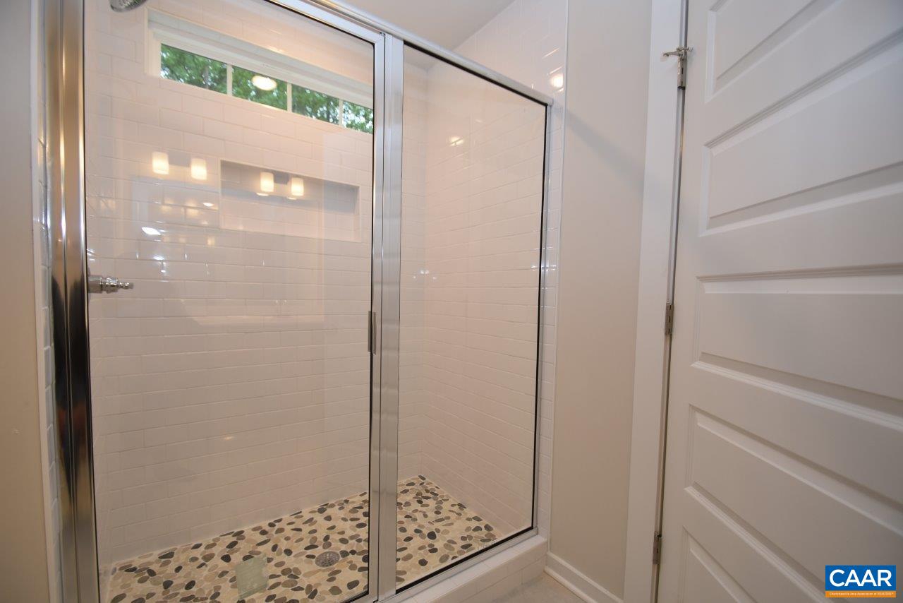 88 Martin Village Road, Unit MV 16D Louisa, VA 23093 - Photo 29 of 37 a bathroom with a glass shower door