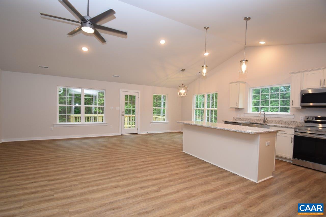 88 Martin Village Road, Unit MV 16D Louisa, VA 23093 - Photo 9 of 37 a large kitchen with kitchen island a stove a sink a window and wooden floor