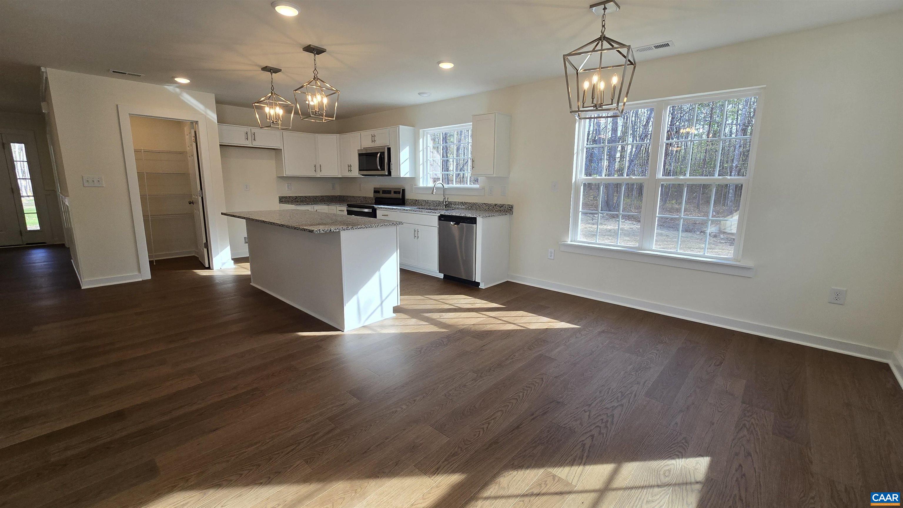 88 Martin Village Road, Unit MV 16D Louisa, VA 23093 - Photo 10 of 41 a large kitchen with granite countertop a large counter top a sink stainless steel appliances and cabinets