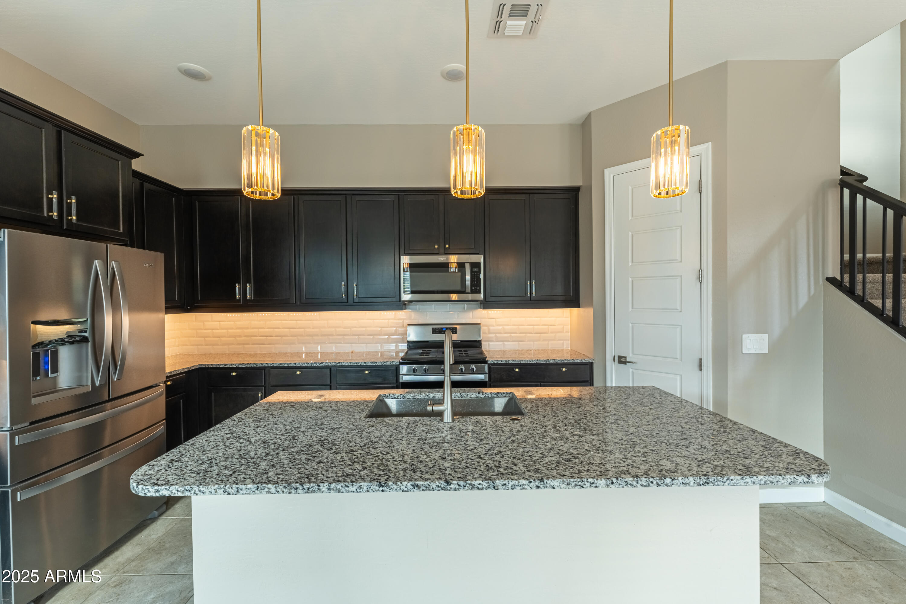 4838 East Helena Drive Scottsdale, AZ 85254 - Photo 5 of 32 a kitchen with stainless steel appliances granite countertop a sink refrigerator and microwave