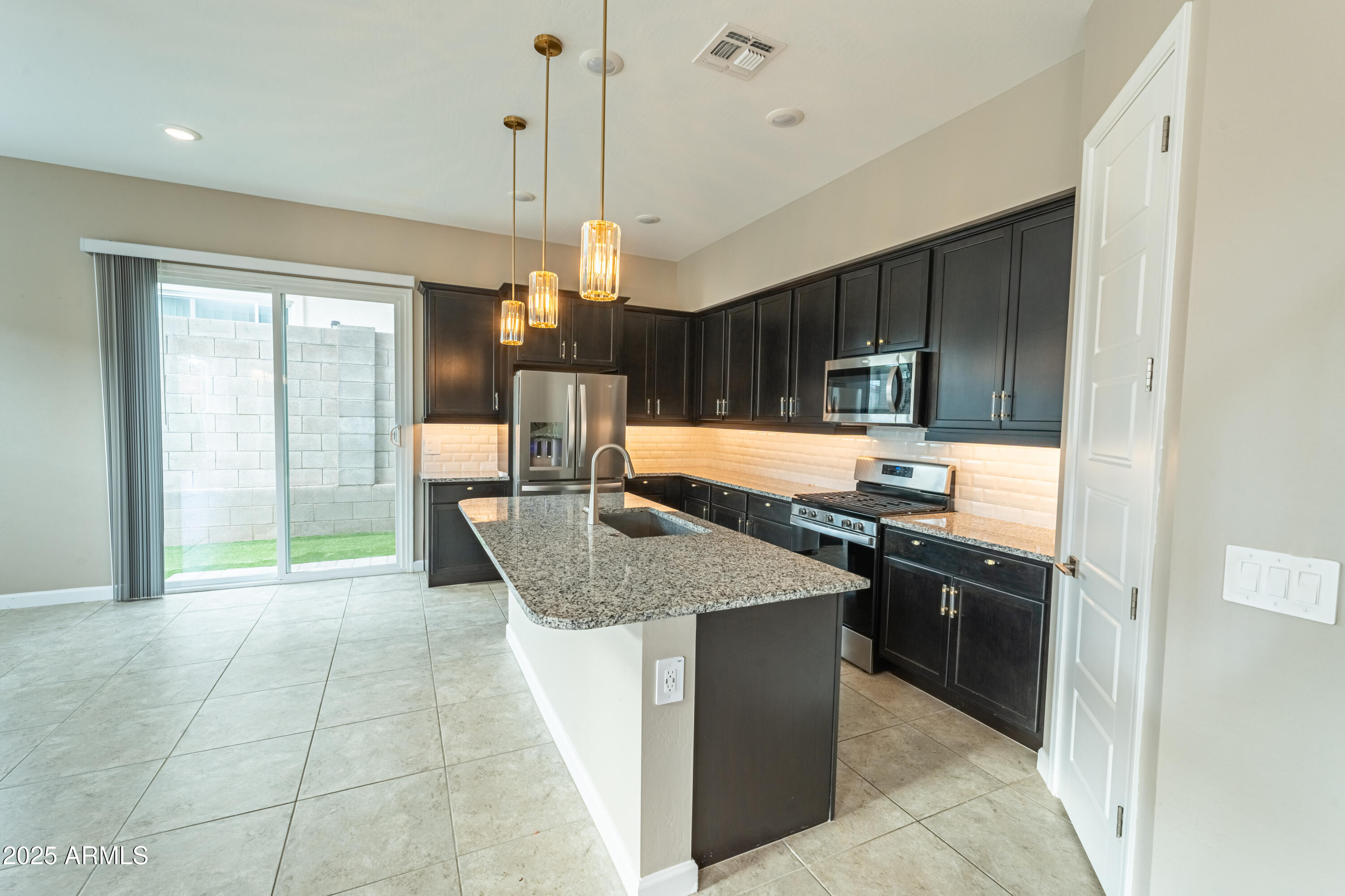4838 East Helena Drive Scottsdale, AZ 85254 - Photo 8 of 32 a kitchen with stainless steel appliances granite countertop a sink a counter space and a window