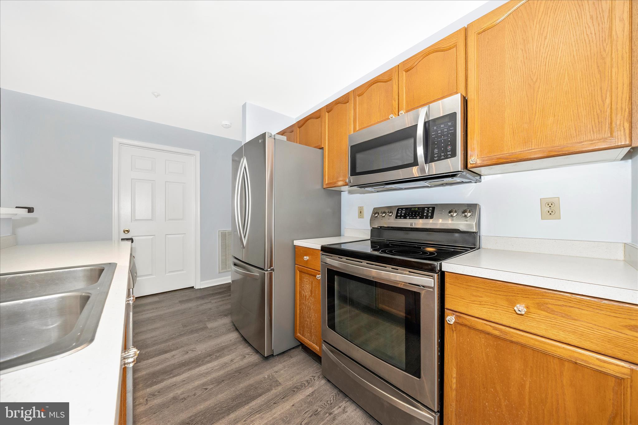 2402 Dominion Drive, Unit 1B Frederick, MD 21702 - Photo 14 of 66 a kitchen with stainless steel appliances a stove microwave and refrigerator