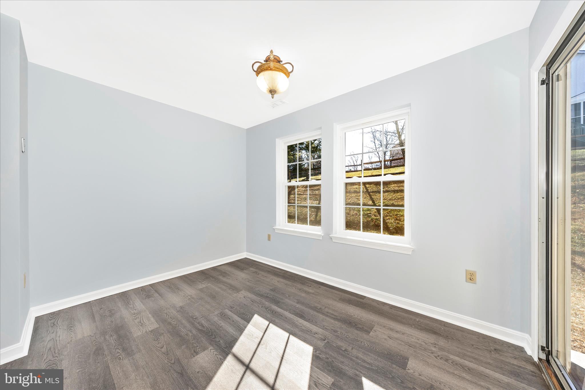 2402 Dominion Drive, Unit 1B Frederick, MD 21702 - Photo 19 of 66 an empty room with wooden floor and windows