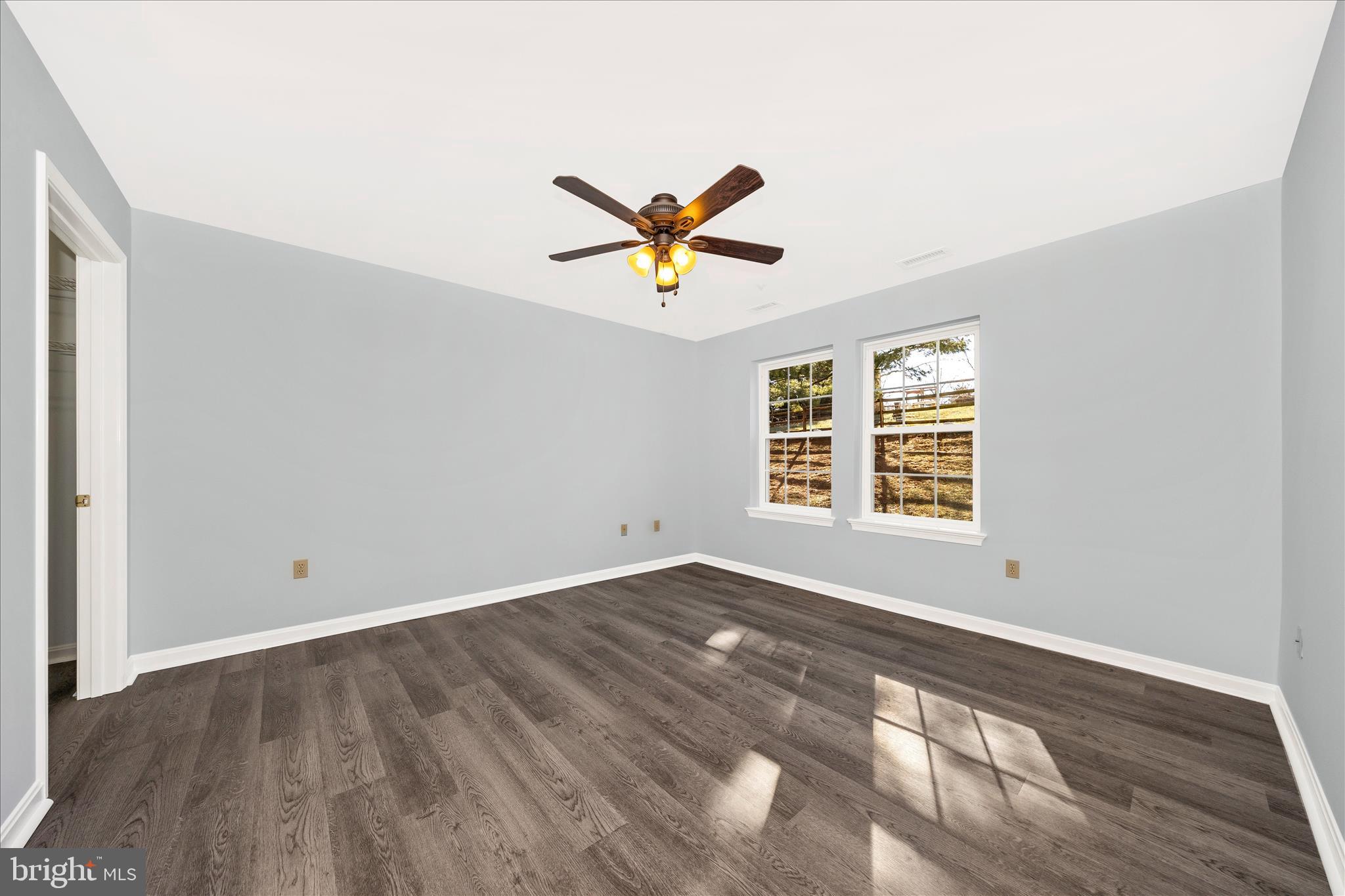 2402 Dominion Drive, Unit 1B Frederick, MD 21702 - Photo 20 of 66 an empty room with window and a ceiling fan