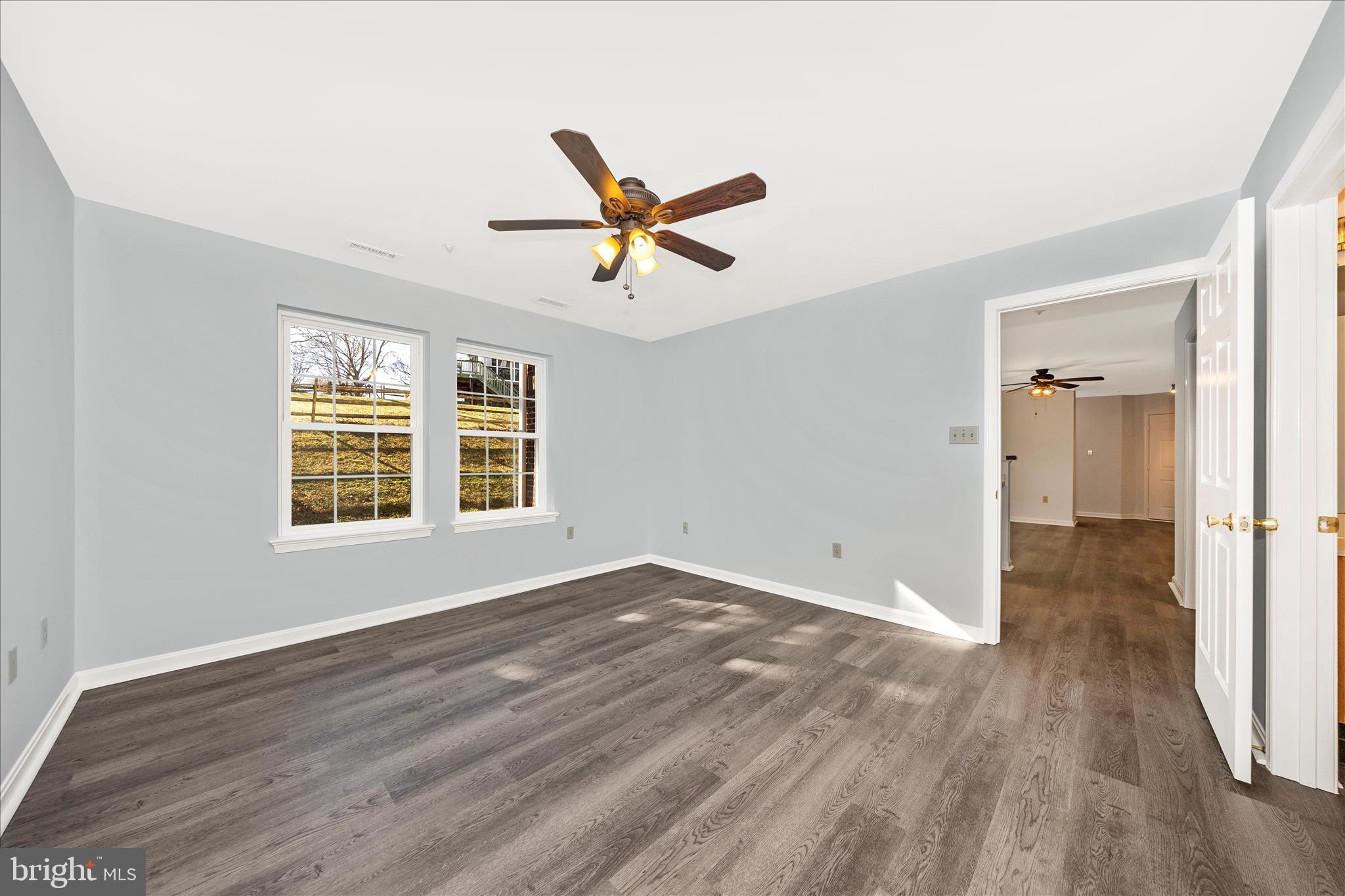 2402 Dominion Drive, Unit 1B Frederick, MD 21702 - Photo 22 of 66 an empty room with wooden floor and windows