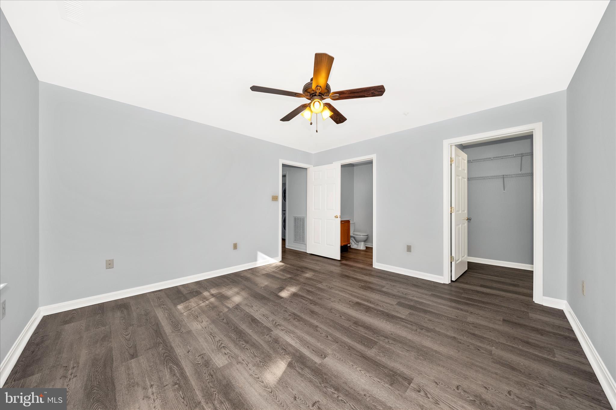 2402 Dominion Drive, Unit 1B Frederick, MD 21702 - Photo 23 of 66 an empty room with wooden floor and ceiling fan