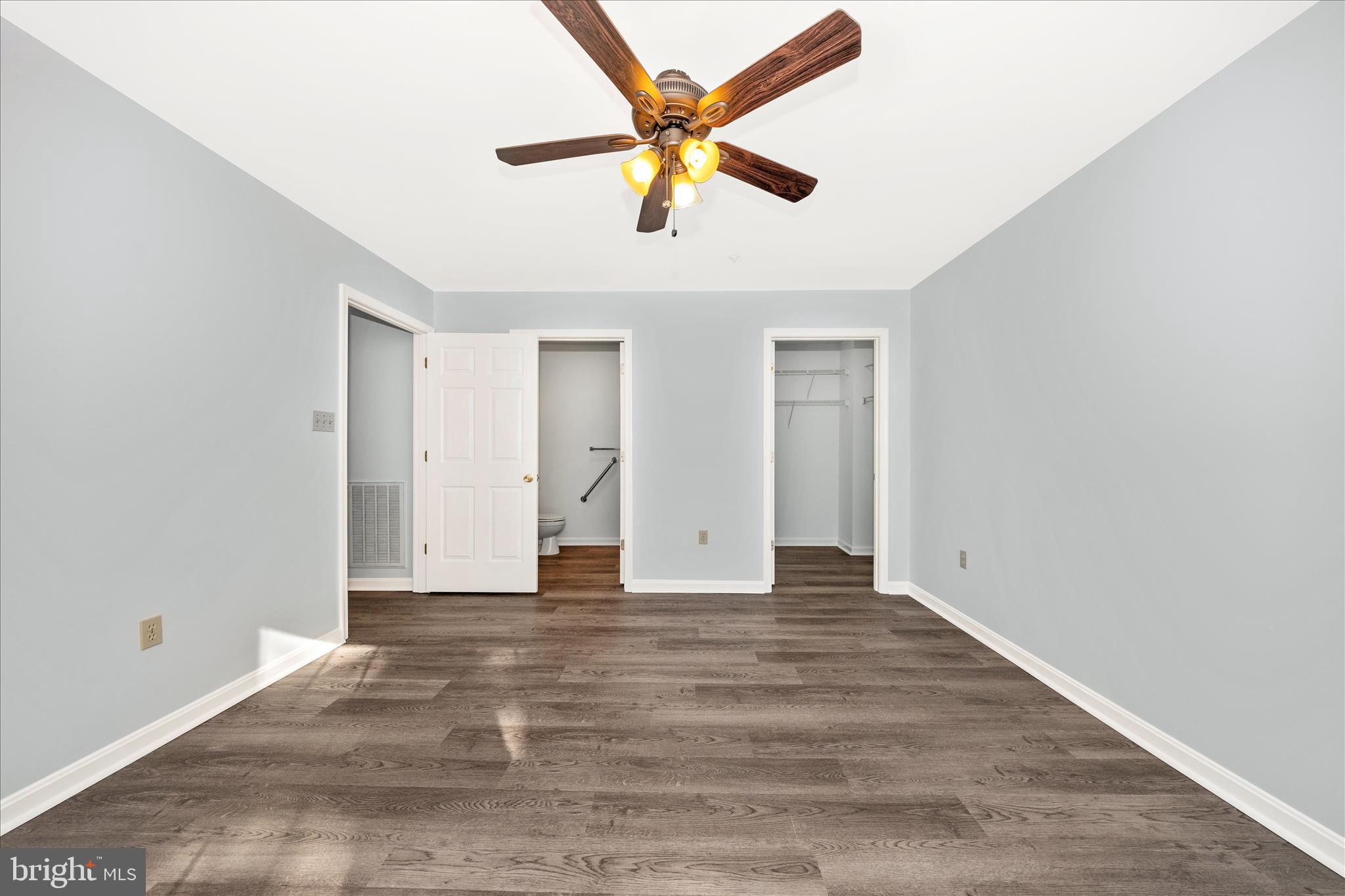2402 Dominion Drive, Unit 1B Frederick, MD 21702 - Photo 24 of 66 a view of an empty room with window and a ceiling fan