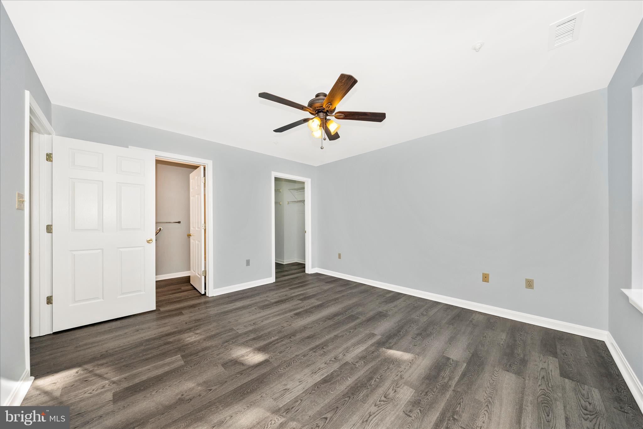 2402 Dominion Drive, Unit 1B Frederick, MD 21702 - Photo 25 of 66 an empty room with wooden floor and a ceiling fan