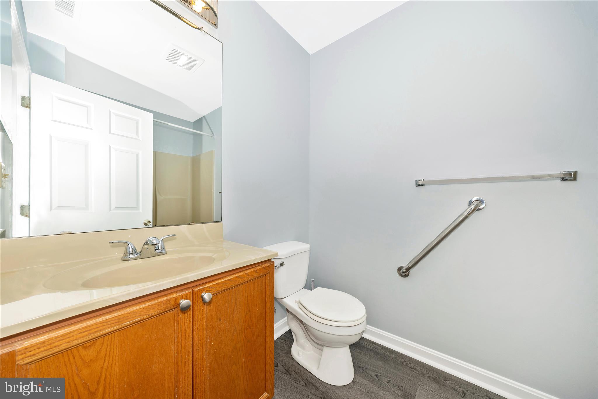 2402 Dominion Drive, Unit 1B Frederick, MD 21702 - Photo 26 of 66 a bathroom with a granite countertop sink mirror vanity and toilet