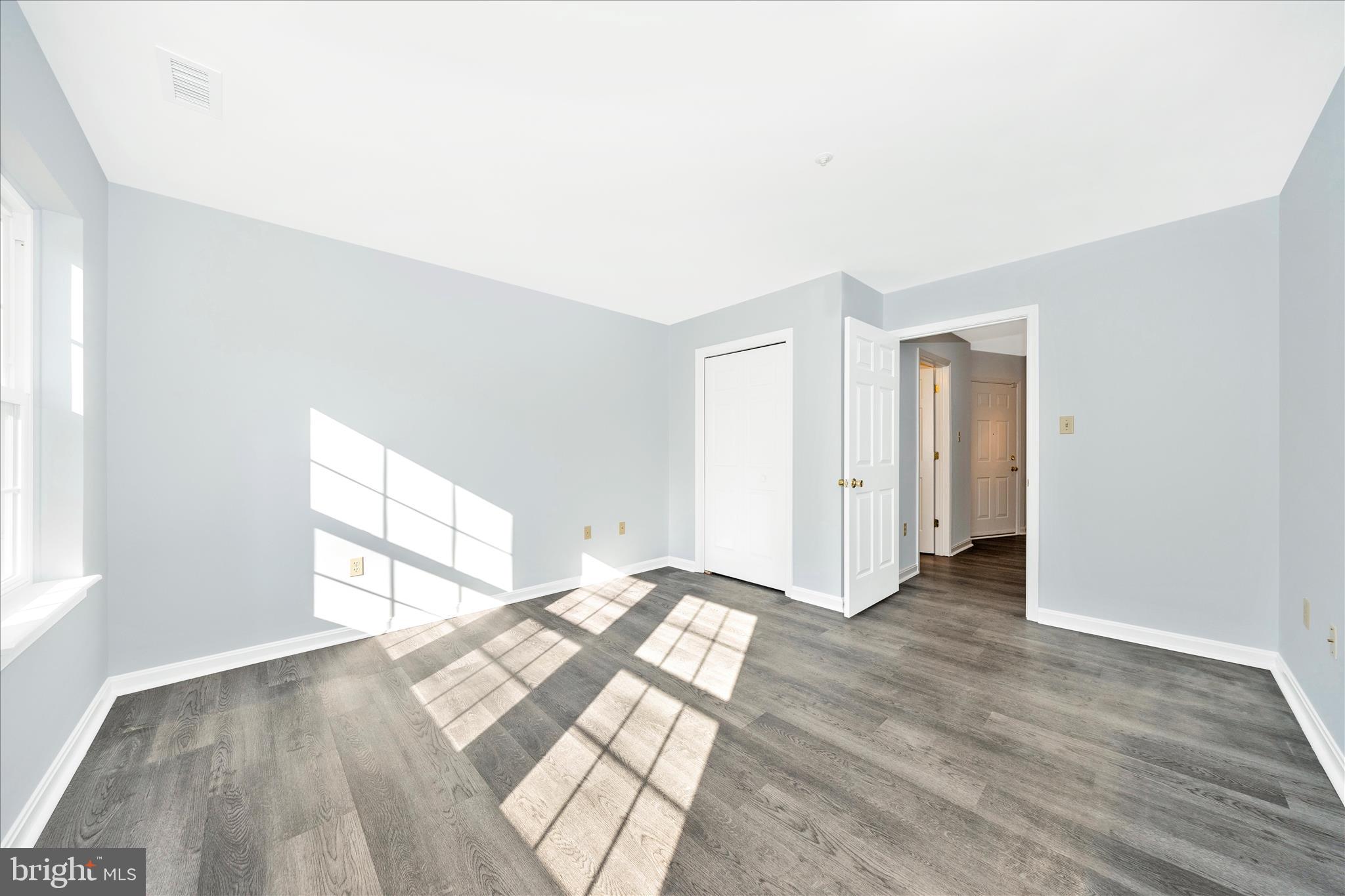 2402 Dominion Drive, Unit 1B Frederick, MD 21702 - Photo 29 of 66 a view of empty room with wooden floor and fan
