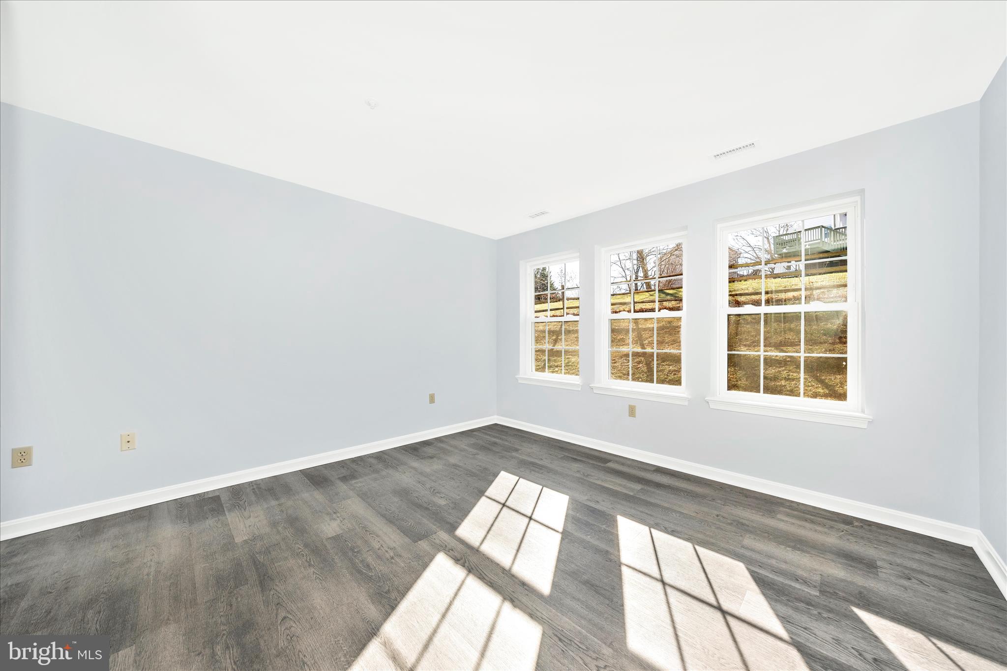 2402 Dominion Drive, Unit 1B Frederick, MD 21702 - Photo 30 of 66 an empty room with wooden floor and windows
