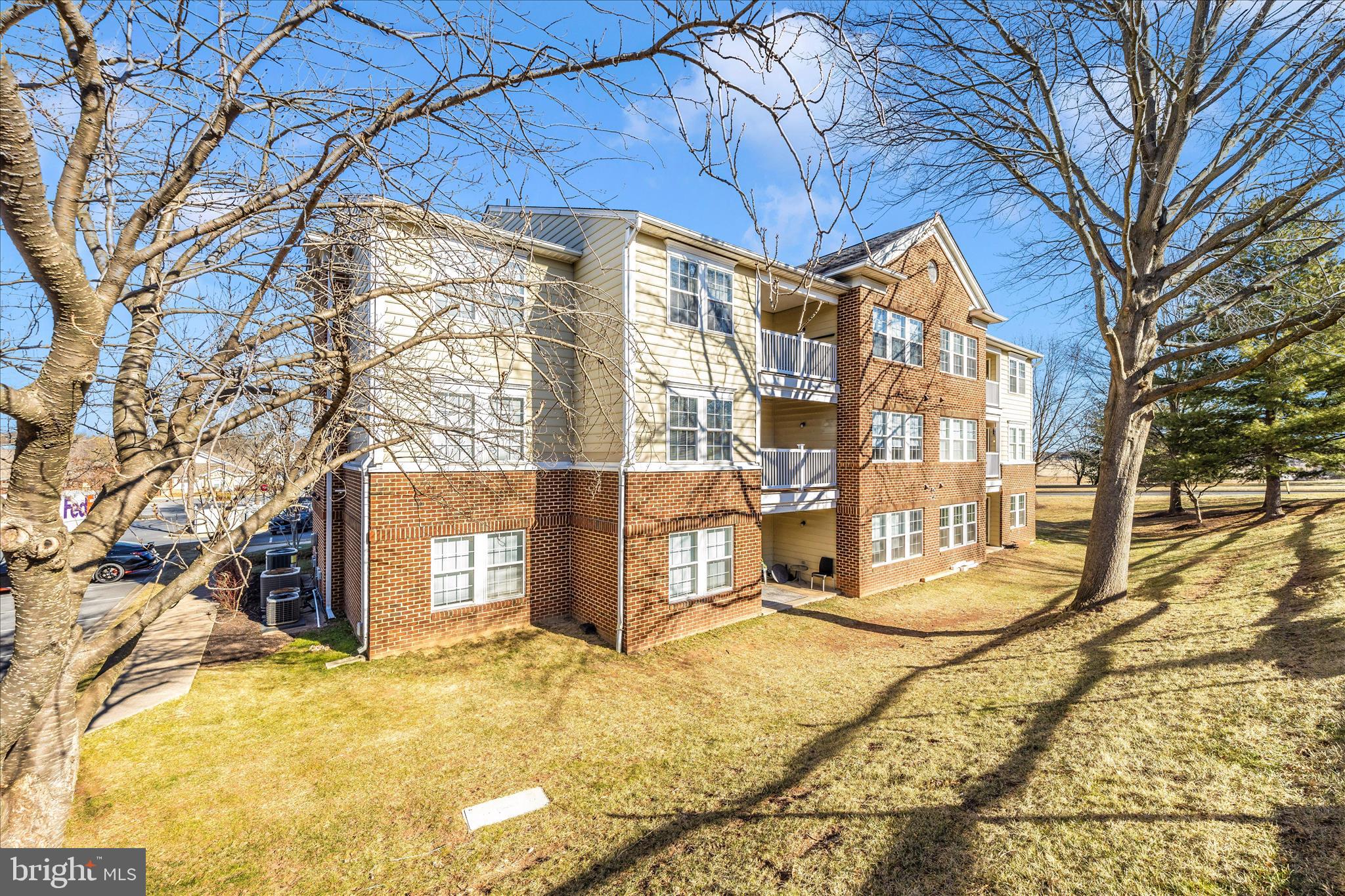 2402 Dominion Drive, Unit 1B Frederick, MD 21702 - Photo 43 of 66 a view of a building with snow on the road