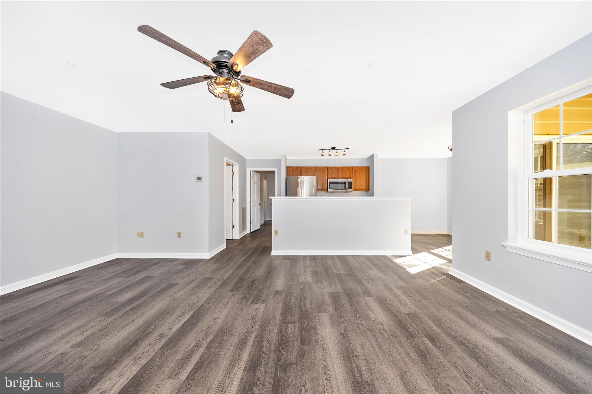 2402 Dominion Drive, Unit 1B Frederick, MD 21702 - Photo 10 of 66 a view of empty room with wooden floor and ceiling fan