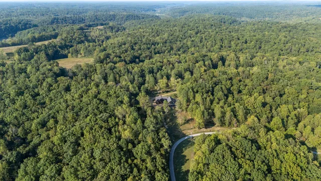 a front view of a house with swimming pool and porch